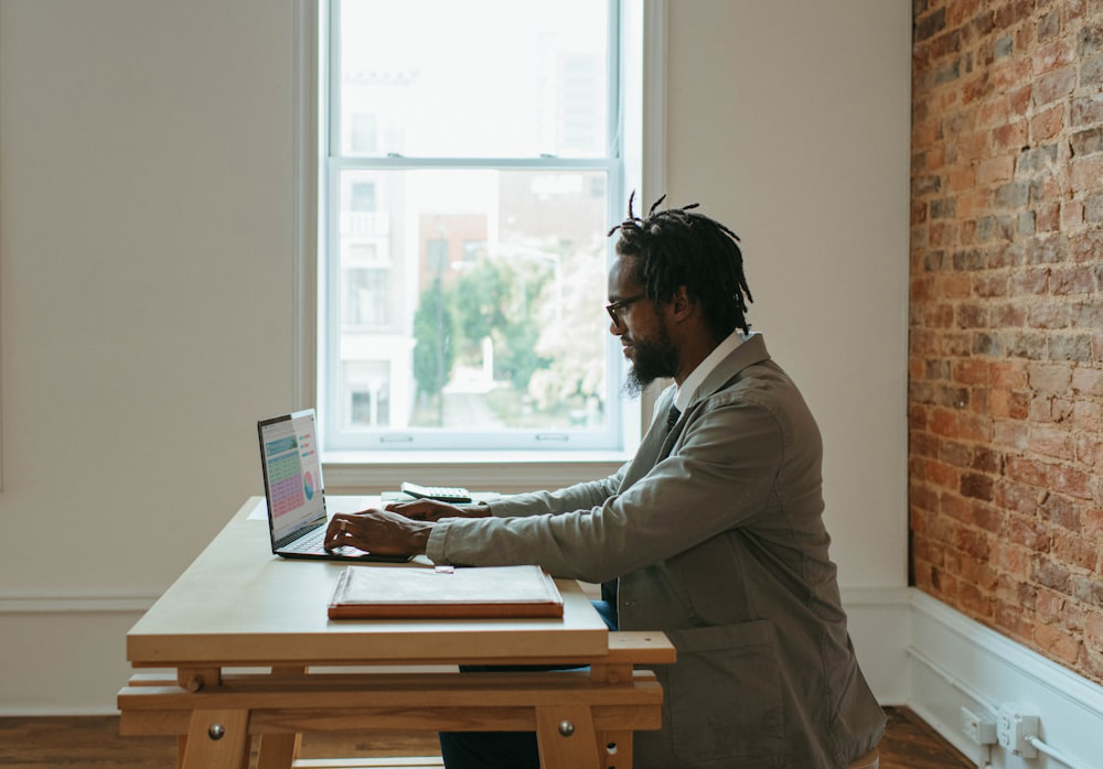 A person sitting at a desk with a laptop and papers.