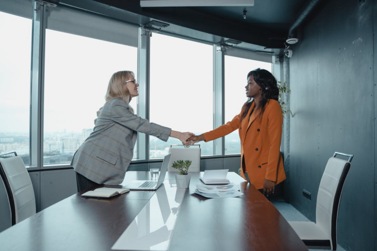 Two women shaking hands after an interview