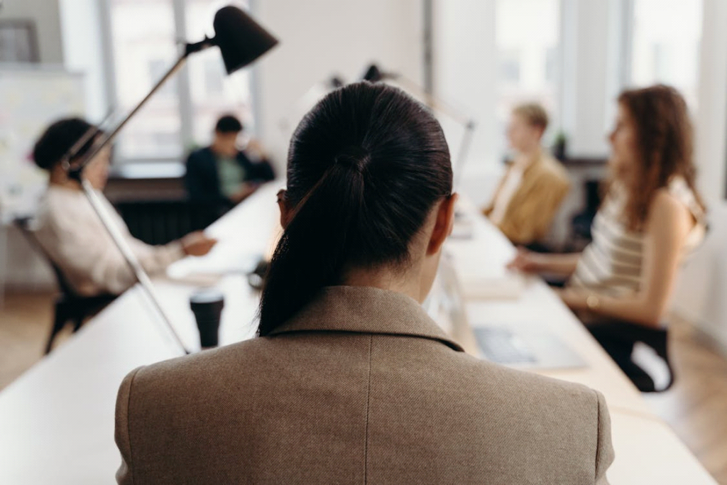 A professional woman seated at a conference table during a medical sales