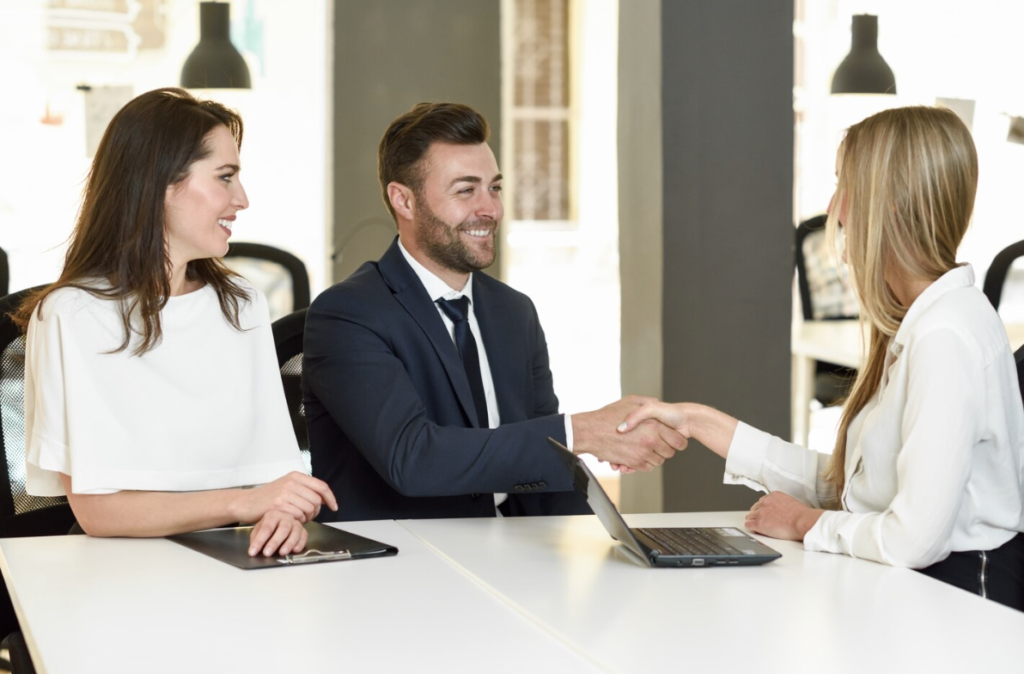 An interviewer shaking a candidate’s hand