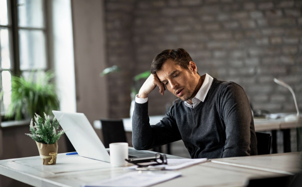 An employee feeling overworked and overwhelmed